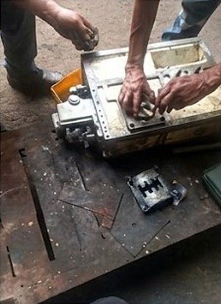 Dos técnicos ensamblando la caja de engranajes sobre la mesa de trabajo